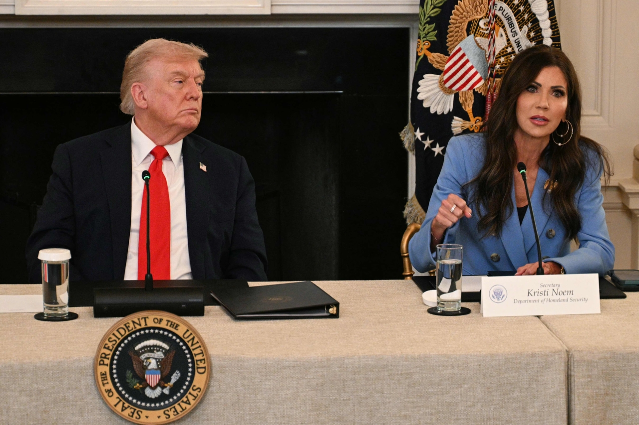 US President Donald Trump (left) listens to Homeland Security Secretary Kristi Noem speak during a roundtable at the White House in Washington, Oct. 8. (AFP-Yonhap)
