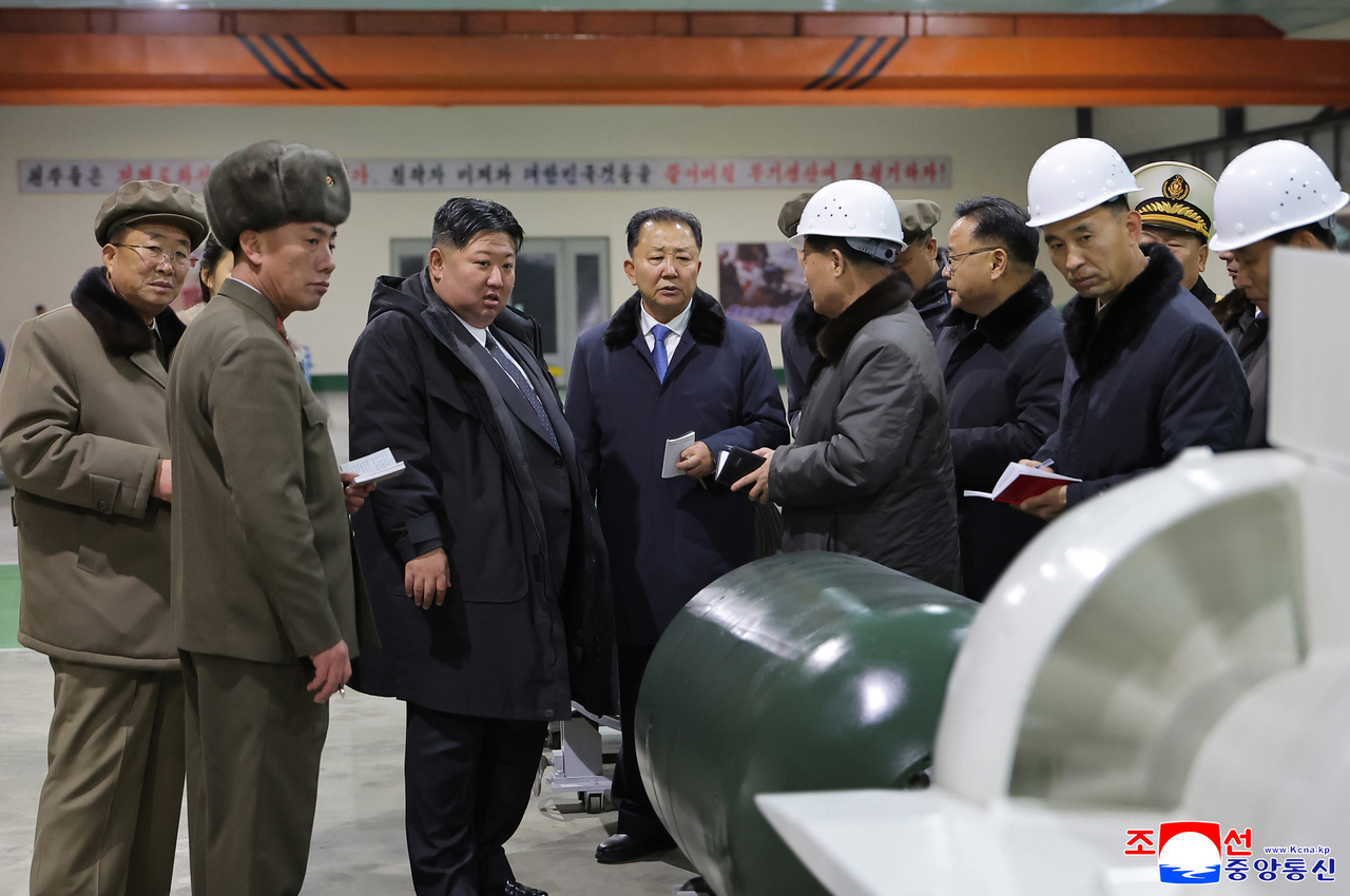 North Korean leader Kim Jong Un visits the construction site of an 8,700-ton nuclear-powered submarine capable of launching surface-to-air missiles in this picture released by North Korea's official Korean Central News Agency on Dec. 25. (KCNA via Yonhap)