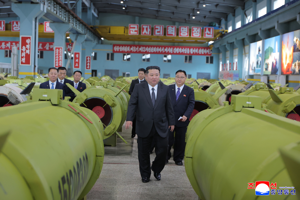 North Korean leader Kim Jong-un is seen inspecting a munitions factory in a photograph published by North Korea state media on Friday. (KCNA via Yonhap)