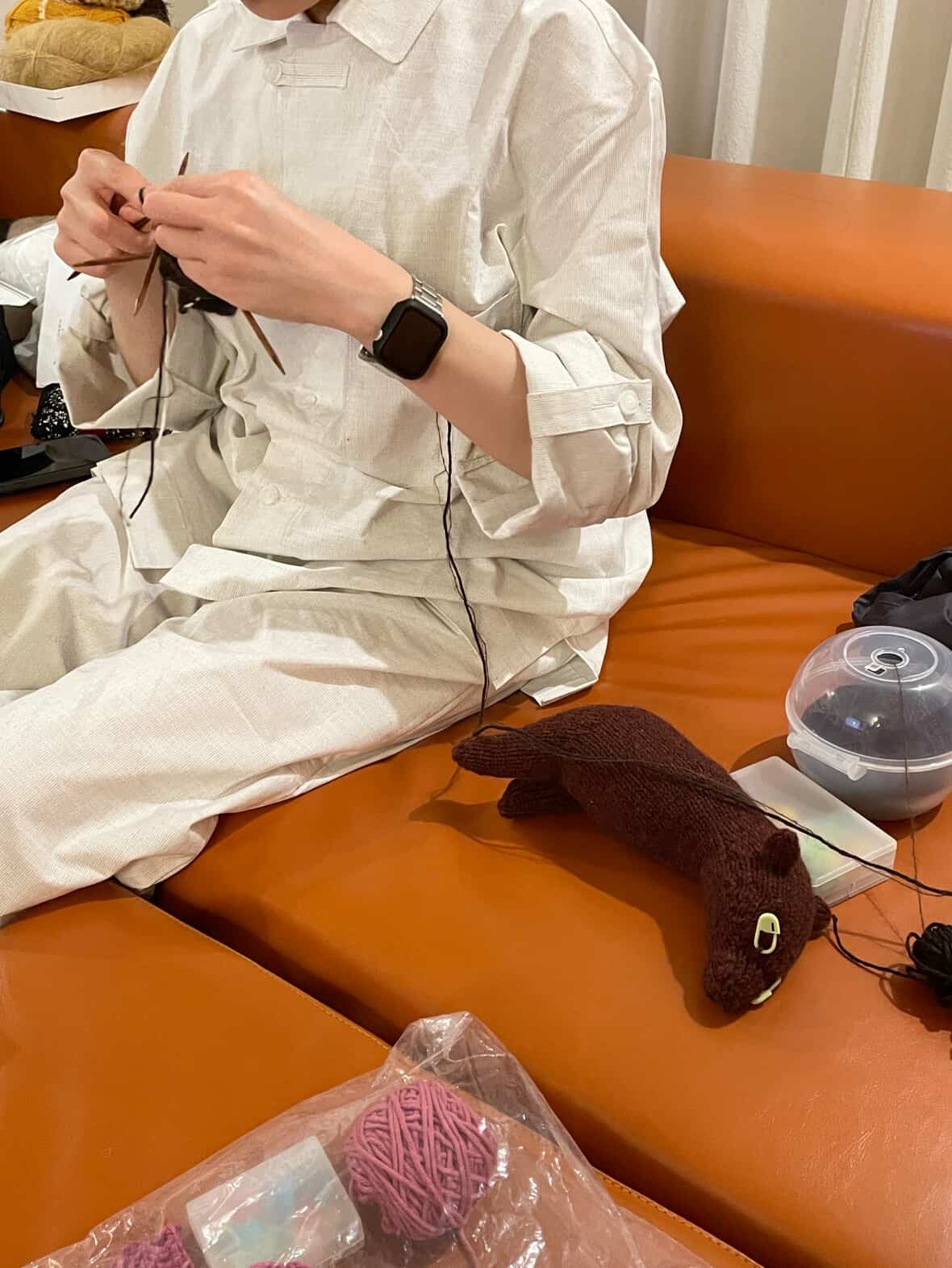 Chung In-young works on a knitted cover for a street tree. (Courtesy of Chung)