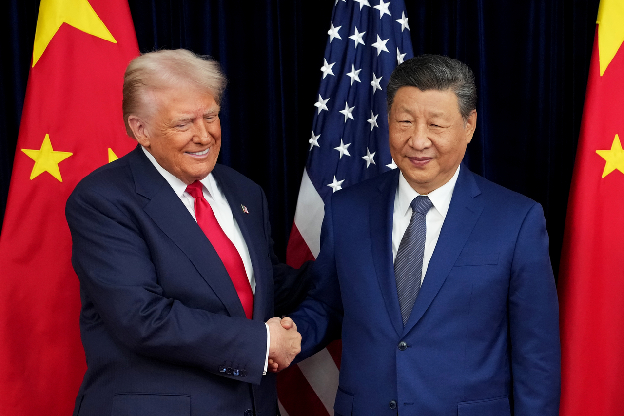 US President Donald Trump greets Chinese President Xi Jinping ahead of a bilateral meeting at Gimhae Air Base in Busan, South Korea, on Oct. 30. (Getty Images)