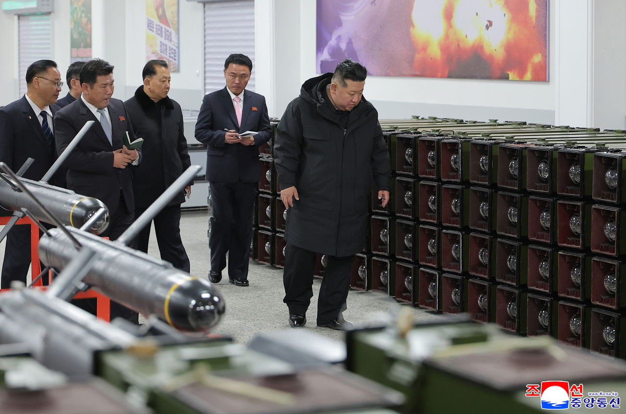 Kim Jong Un inspects a factory producing multipurpose precision-guided weapons in North Korea on Saturday. (KCNA via Yonhap).