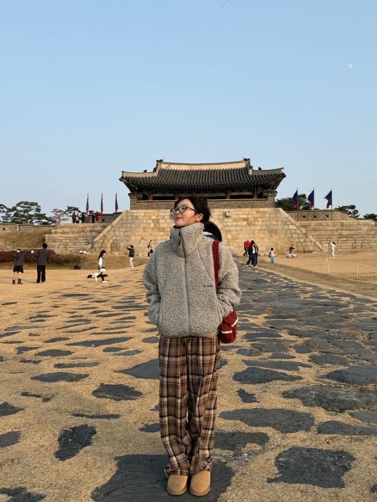 Red Velvet’s Seulgi paired a gray high-neck fleece with classic plaid pants and chunky boots. (Instagram)
