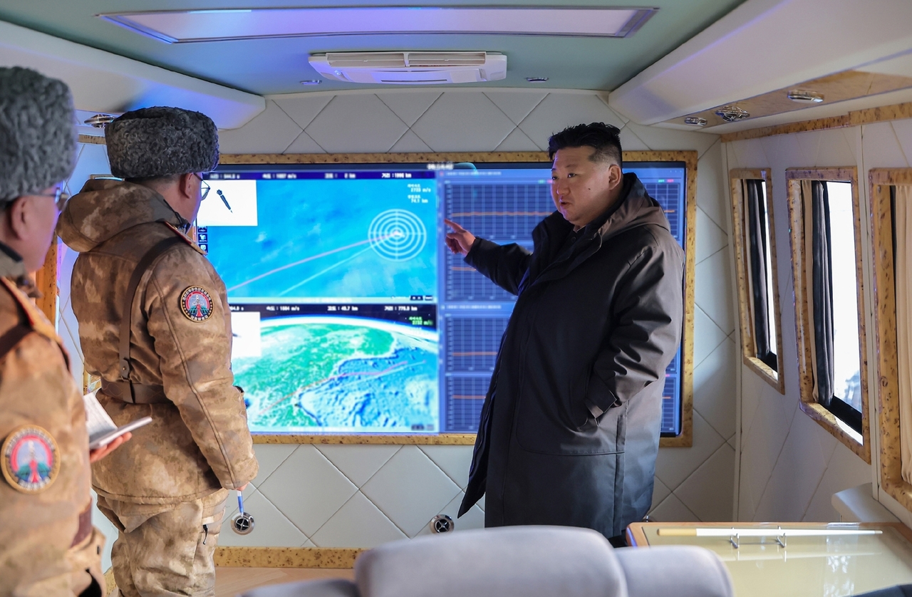 North Korean leader Kim Jong-un oversees a test launch of hypersonic missiles in Pyongyang by a subunit under a major firing strike group of the Korean People's Army on Sunday, in this Korean Central News Agency photo. (KCNA-Yonhap)