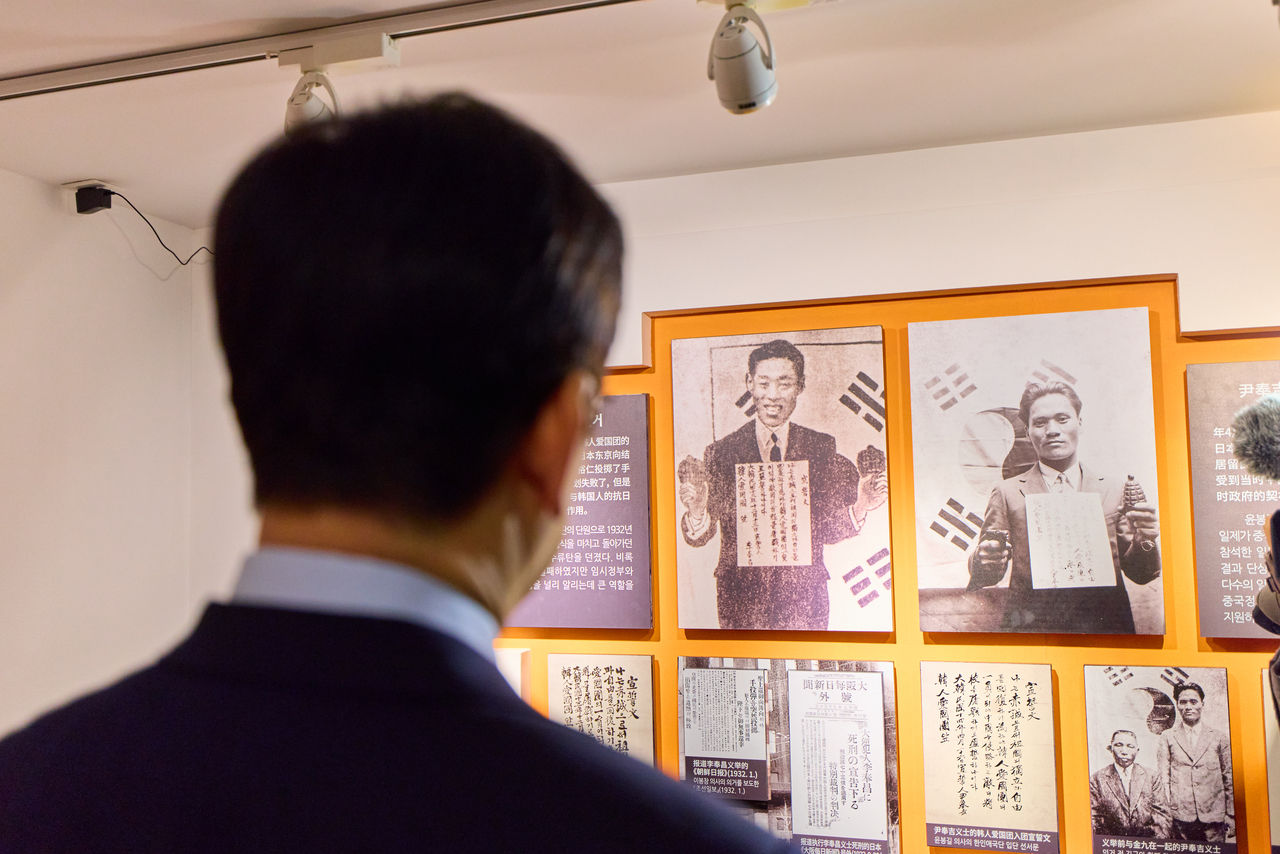 President Lee Jae Myung and first lady Kim Hyea Kyung view photographs of independence activists during their visit to the former headquarters of the Provisional Government of the Republic of Korea in Shanghai on Wednesday. (Pool photo via Yonhap)
