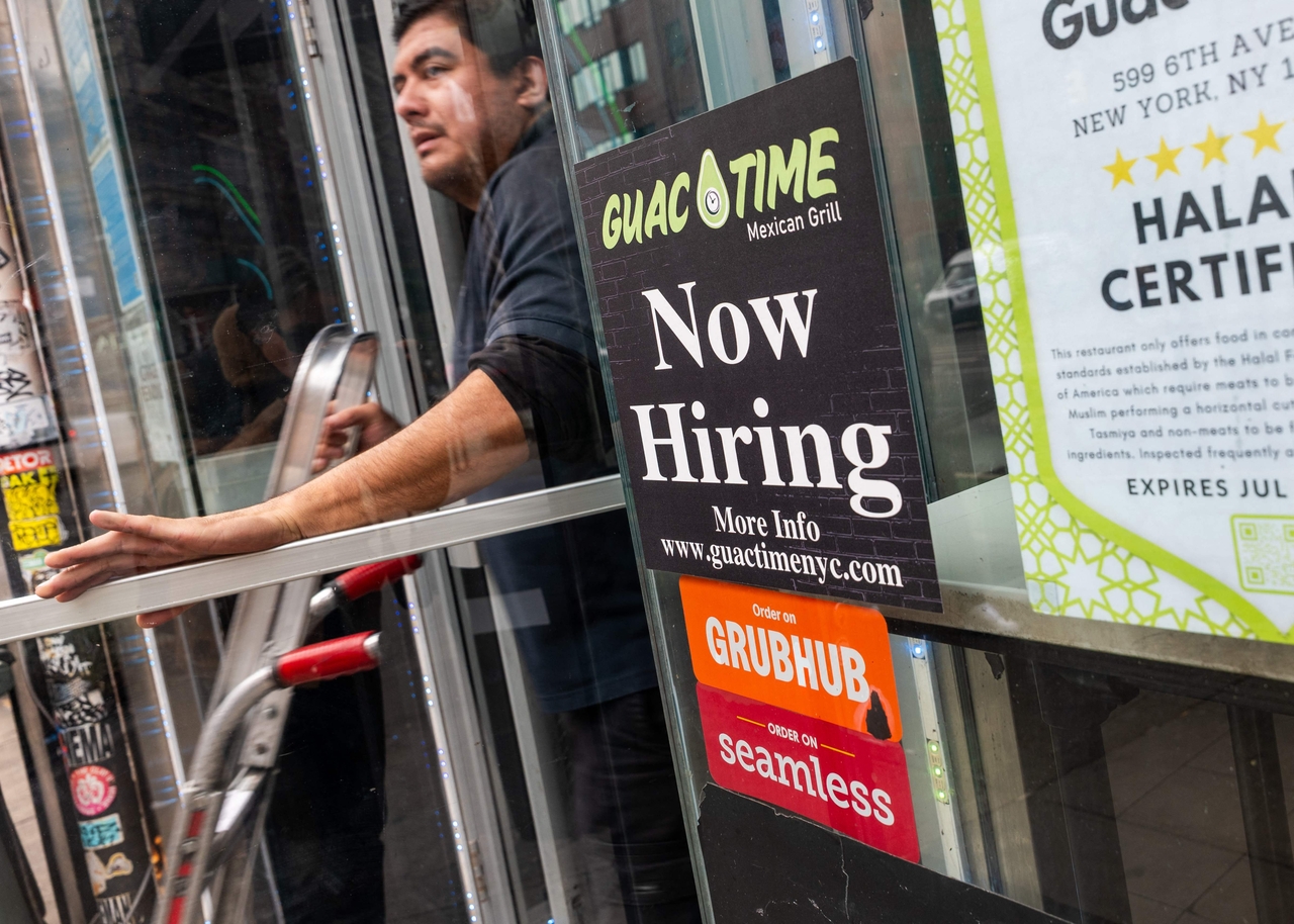 A 'now hiring' sign is displayed in a business's window in Manhattan on Friday.  AFP-Yonhap