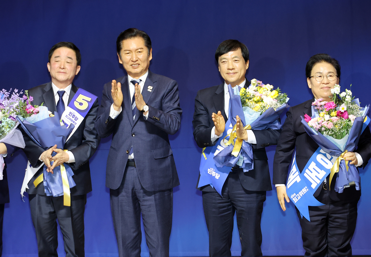 Reps. Kang Deuk-gu (from left(), Jung Chung-rae, Lee Sung-yoon and Moon Jeong-bok pose for a photo after Kang, Lee and Moon were elected as the new Supreme Council members of the Democratic Party of Korea held in the National Assembly Sunday. (Yonhap)