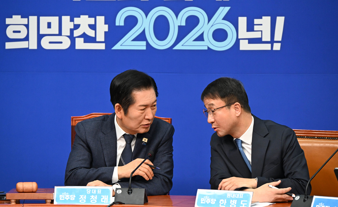 Democratic Party of Korea Chair Rep. Jung Chung-rae (left) and Floor Leader Rep. Han Byung-do converse during a meeting of the party's supreme council on Monday. (Lee Sang-sub/The Korea Herald)