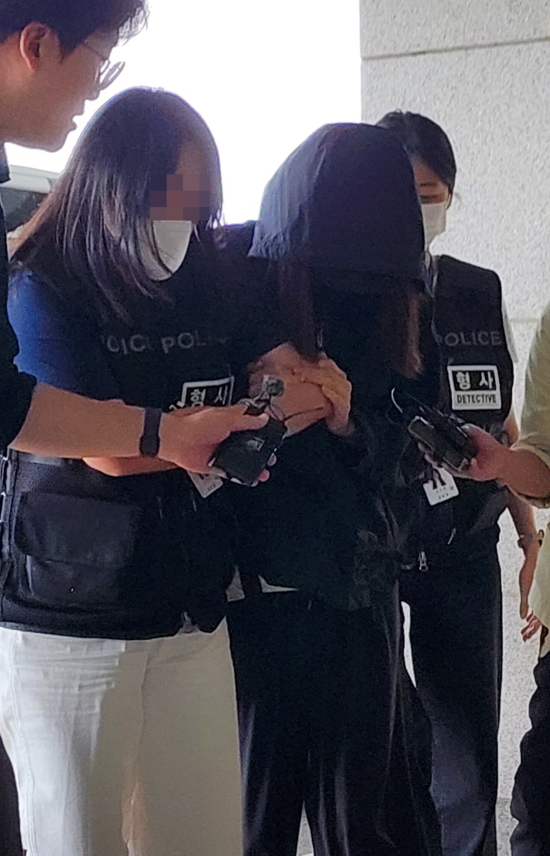 A mother who has later sentenced for stealing tests from her daughter's school enters a court in Daegu for an interrogation before arrest on July 15, 2025. (Newsis)