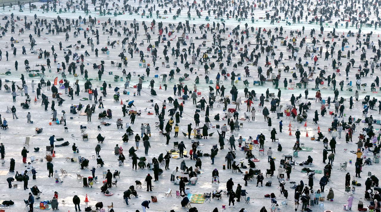 Visitors crowd the ice fishing site at the 2026 Hwacheon Sancheoneo Ice Festival held in and around the Hwacheon Stream in Hwacheon County, Gangwon Province, on Jan. 17, 2026. (Hwacheon County Office-Yonhap)