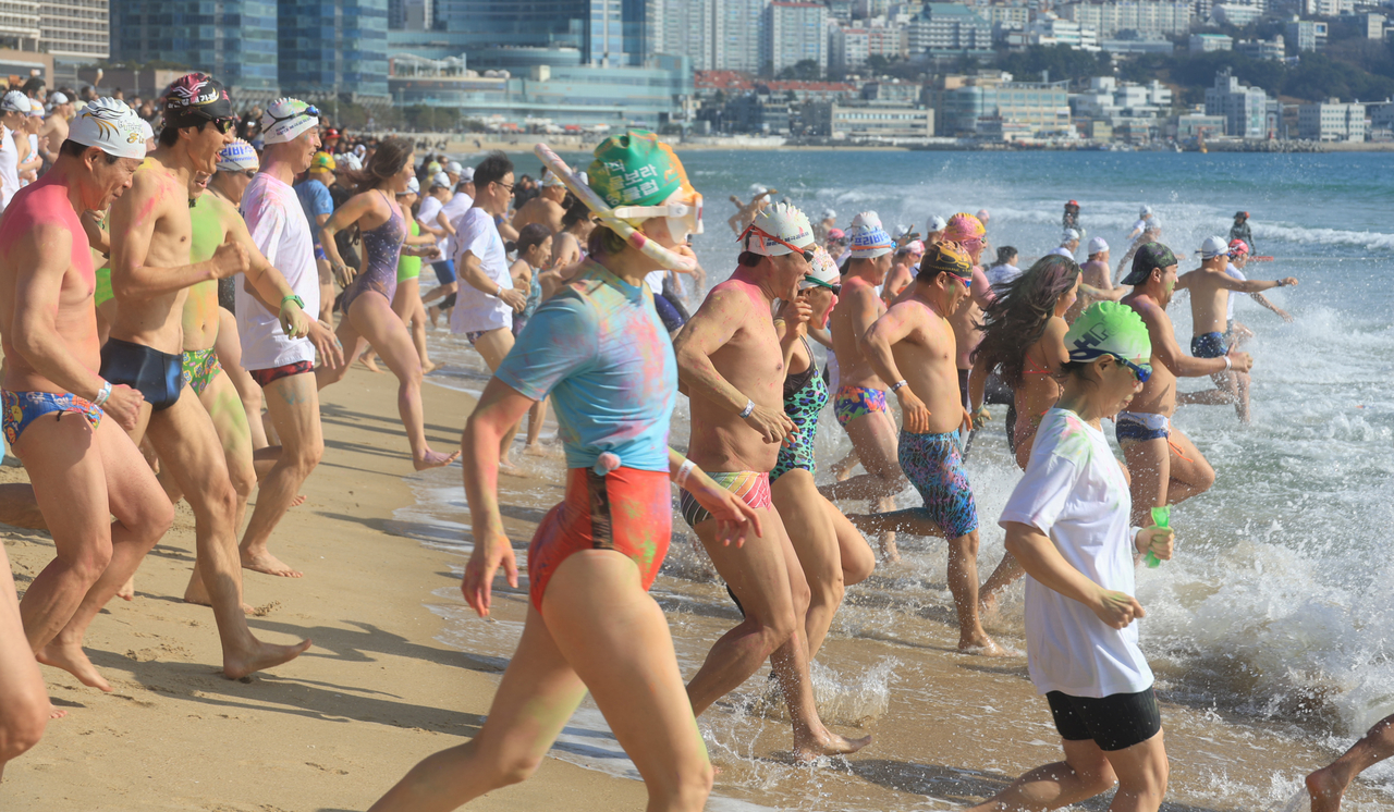 Participants head toward the sea during the 39th Polar Bear Festival at Haeundae Beach in Busan on Sunday. (Yonhap)