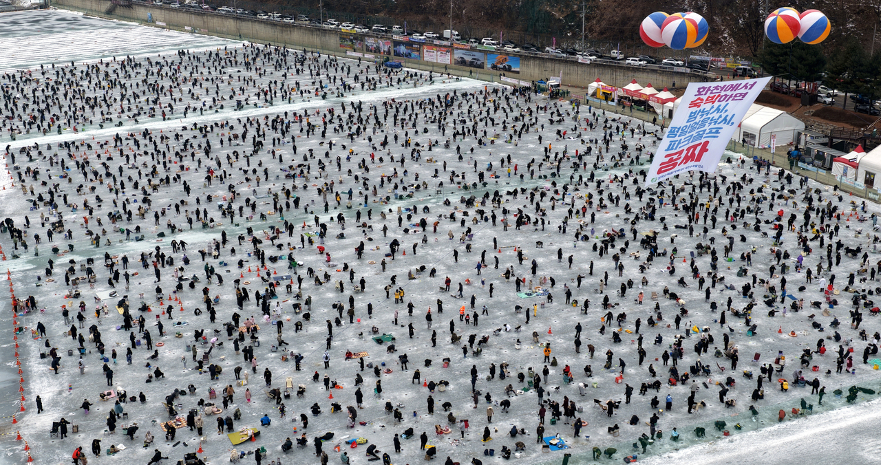 Visitors enjoy winter fishing during the Hwacheon Sancheoneo Ice Festival in Hwacheon County, Gangwon Province, on Saturday. (Yonhap)