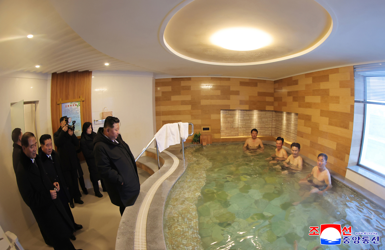 North Korea's leader Kim Jong-un (left) looks around the Onpho Working People's Holiday Camp in North Hamgyong Province on Tuesday. (KCNA via Yonhap)