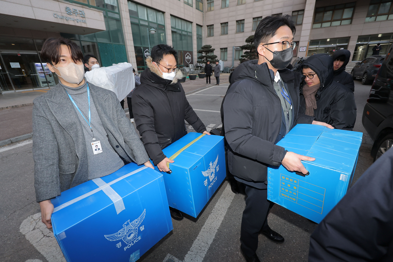 Police officers carry seized materials out of an engineering building at a university in Seoul on Wednesday, as a joint military-police task force probing North Korea’s claims of South Korean drone incursions conducted raids on the homes and offices of three civilian suspects. (Yonhap)