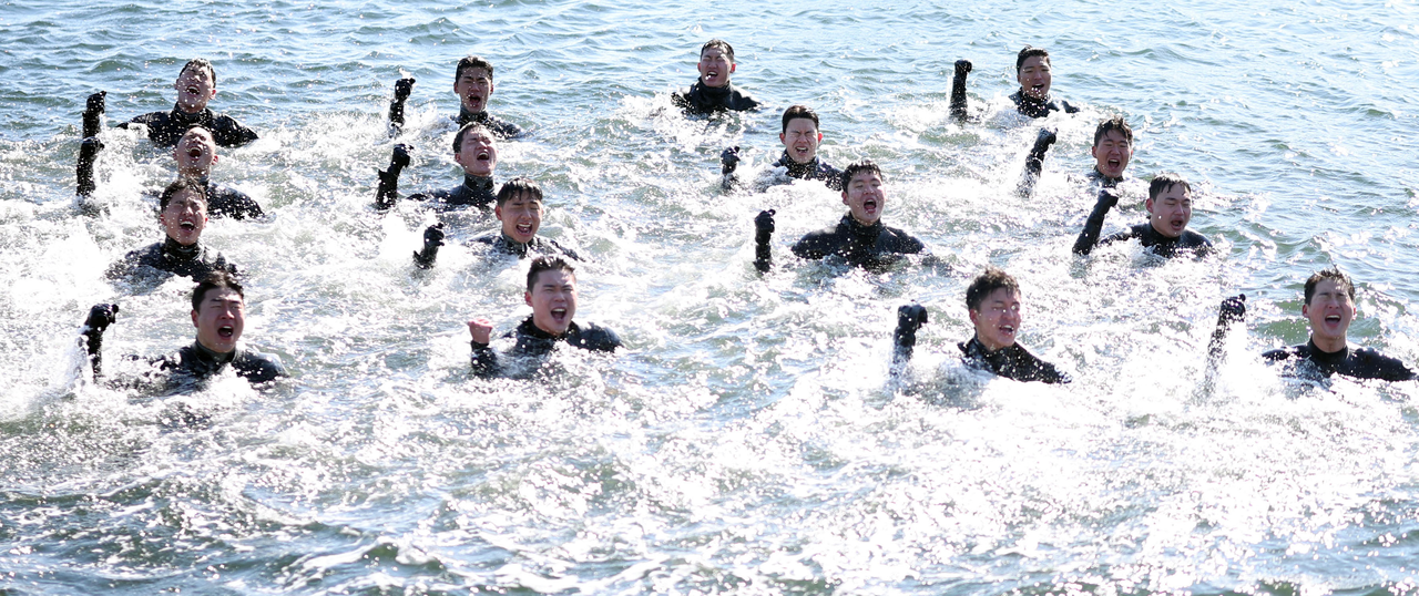 Navy deep-sea divers from the SSU unit sing military songs at full voice during cold-weather training at Jinhae Naval Port in Jinhae-gu, Changwon, South Gyeongsang Province, on Thursday. The temperature in Jinhae fell to minus 6 degrees Celsius, with wind chills dropping to minus 11 degrees. (Yonhap)