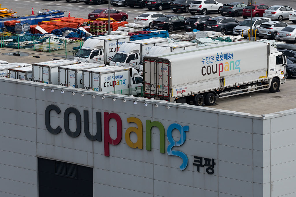 Coupang delivery trucks are parked at the company's fulfillment center in Goyang, Gyeonggi Province, on Dec. 15, 2025. (Getty Images)