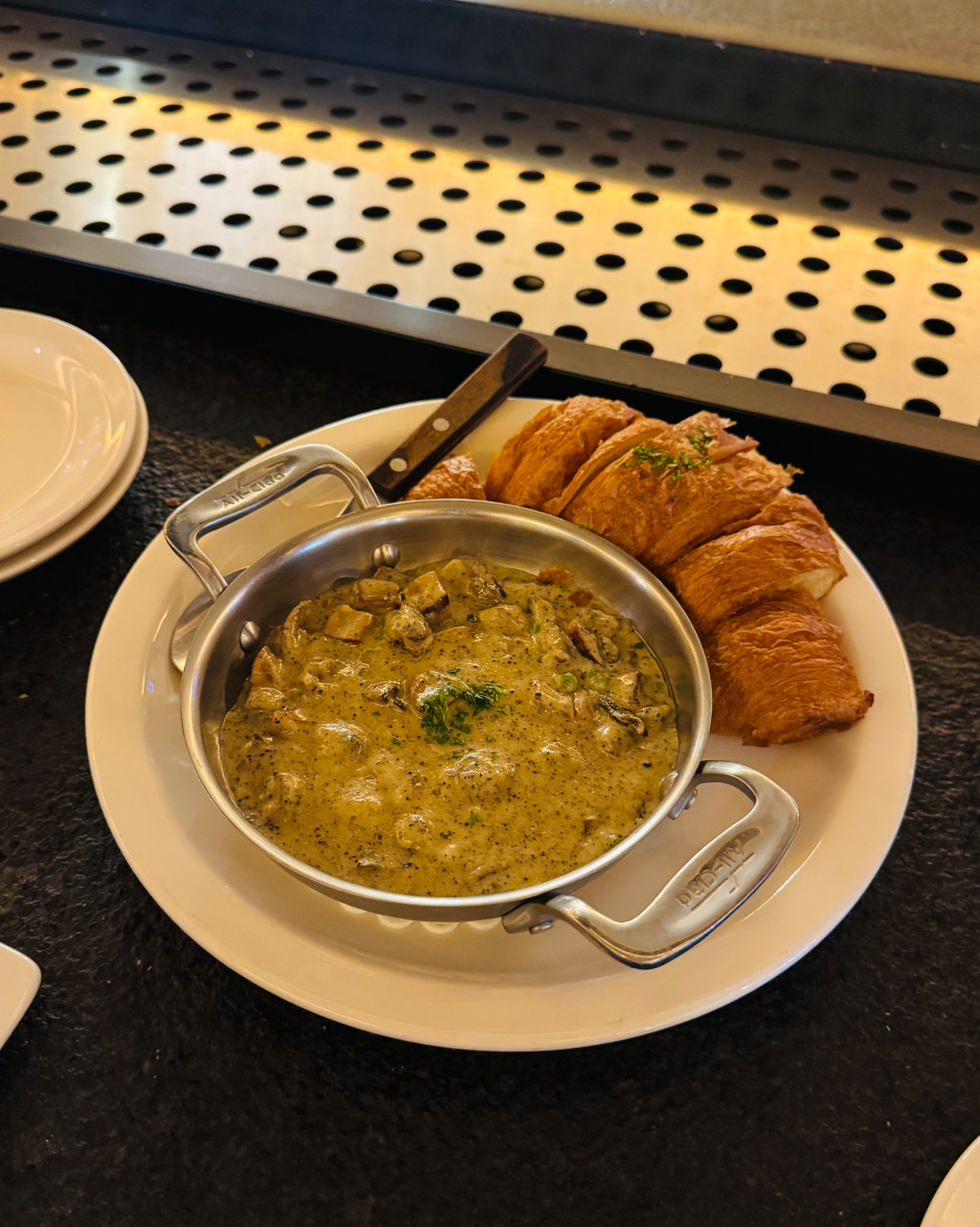 Mushroom cream sea conch with croissant at Dozen Oyster Hannam (Hong Yoo/The Korea Herald)