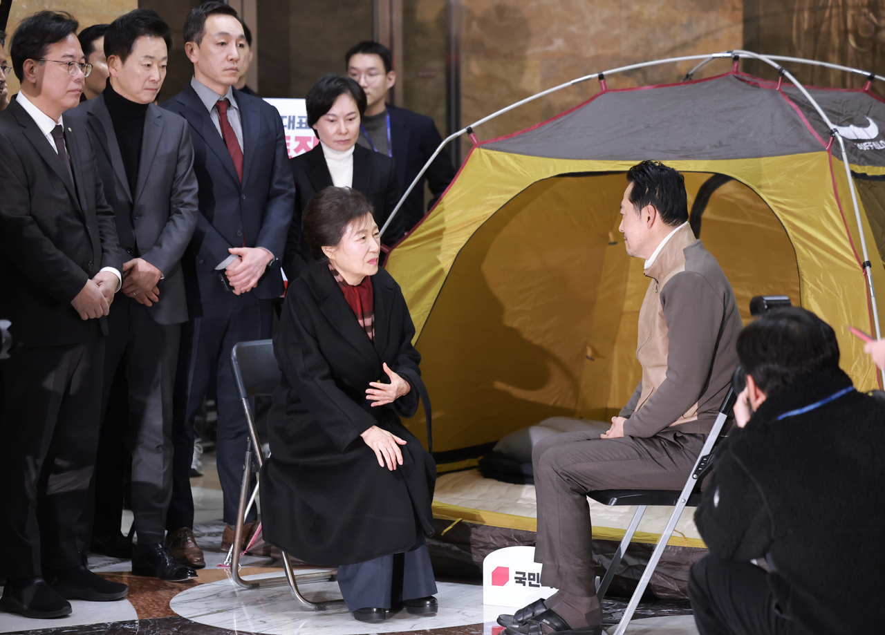 Former President Park Geun-hye (center) speaks with Rep. Jang Dong-hyeok (right), chair of the main opposition People Power Party, during a meeting at the National Assembly in Seoul on Thursday. (Yonhap)