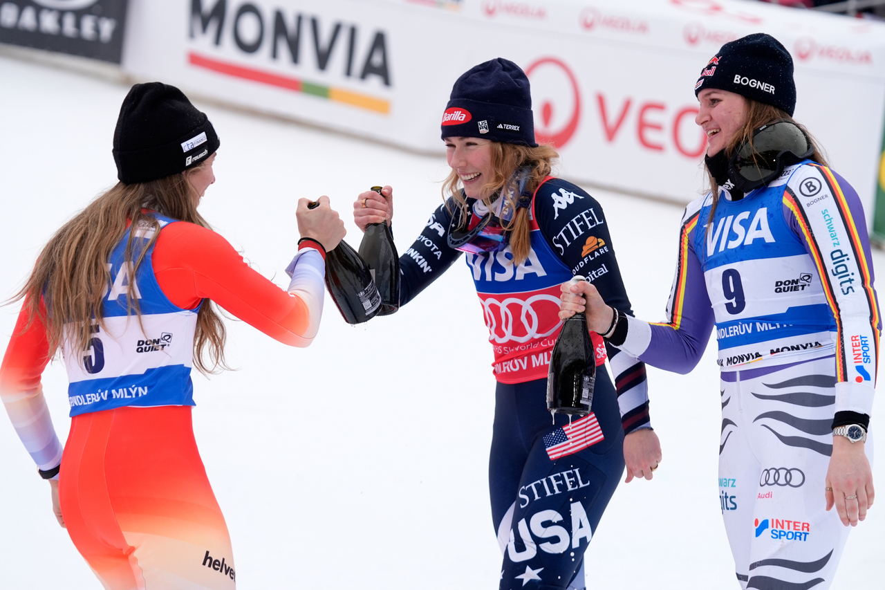 United States' Mikaela Shiffrin, center, winner of an alpine ski, women's World Cup slalom, celebrates with second placed Switzerland's Camille Rast, left, and third placed Germany's Emma Aicher, in Spindleruv Mlyn, Czech Republic, Sunday. (AP Photo/Giovanni Auletta)