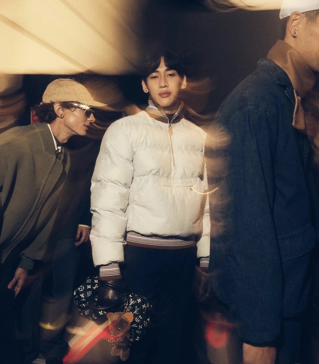 BamBam (center) of the K-pop group Got7, Louis Vuitton’s global ambassador, walked for the brand's show in a compact padded quarter-zip and slim black trousers. (Louis Vuitton)