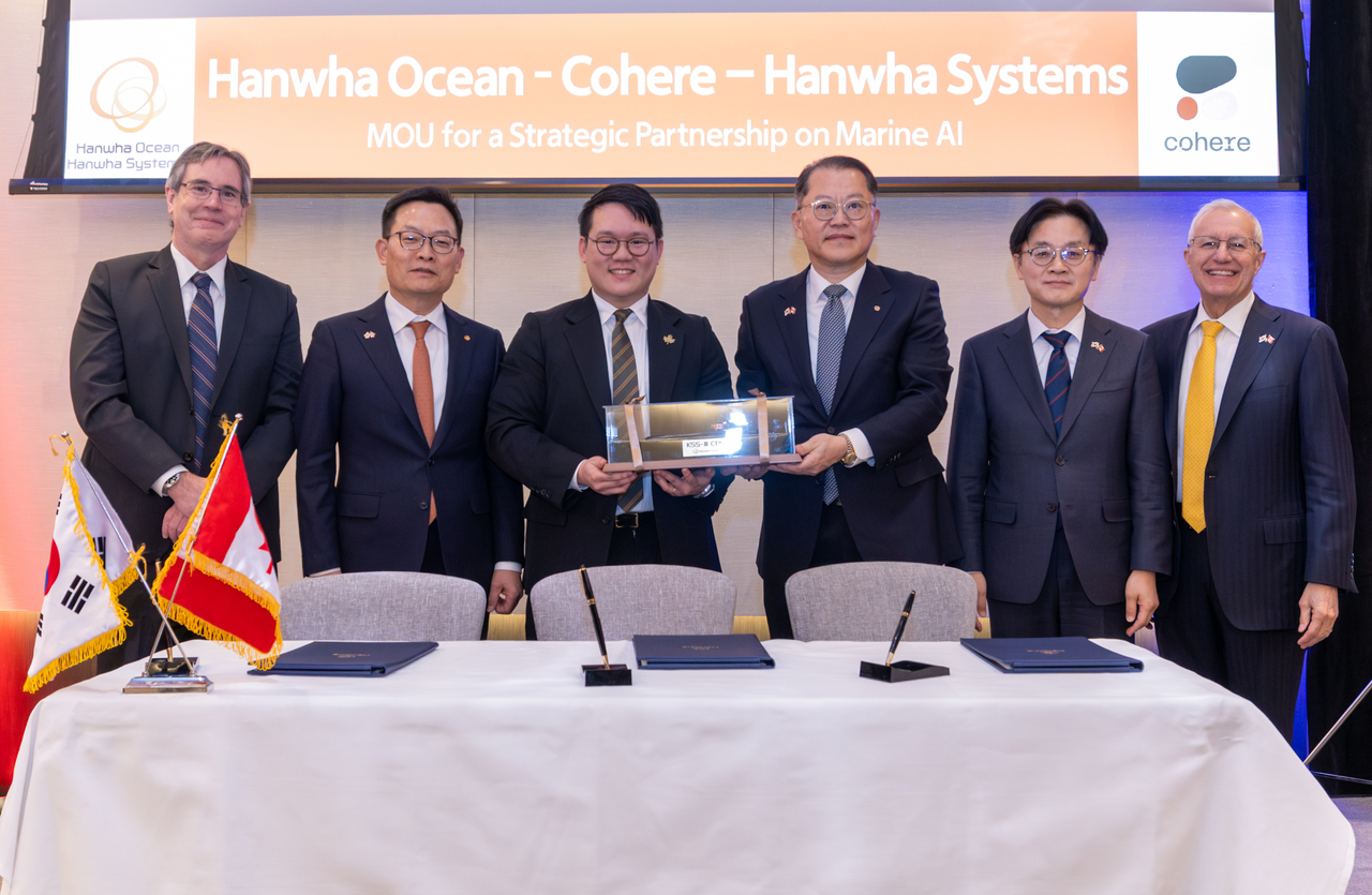 From left: Philip Jennings, Canada's deputy minister of innovation, science and economic development; Son Jae-il, CEO of Hanwha Systems; Ivan Zhang, co-founder of Cohere; Kim Hee-cheul, CEO of Hanwha Ocean; South Korean Industry Minister Kim Jung-kwan and Victor Fedeli, Ontario's minister of economic development, pose after Hanwha Group signed memorandums of understanding with five Canadian companies Monday in Toronto. (Hanwha Group)