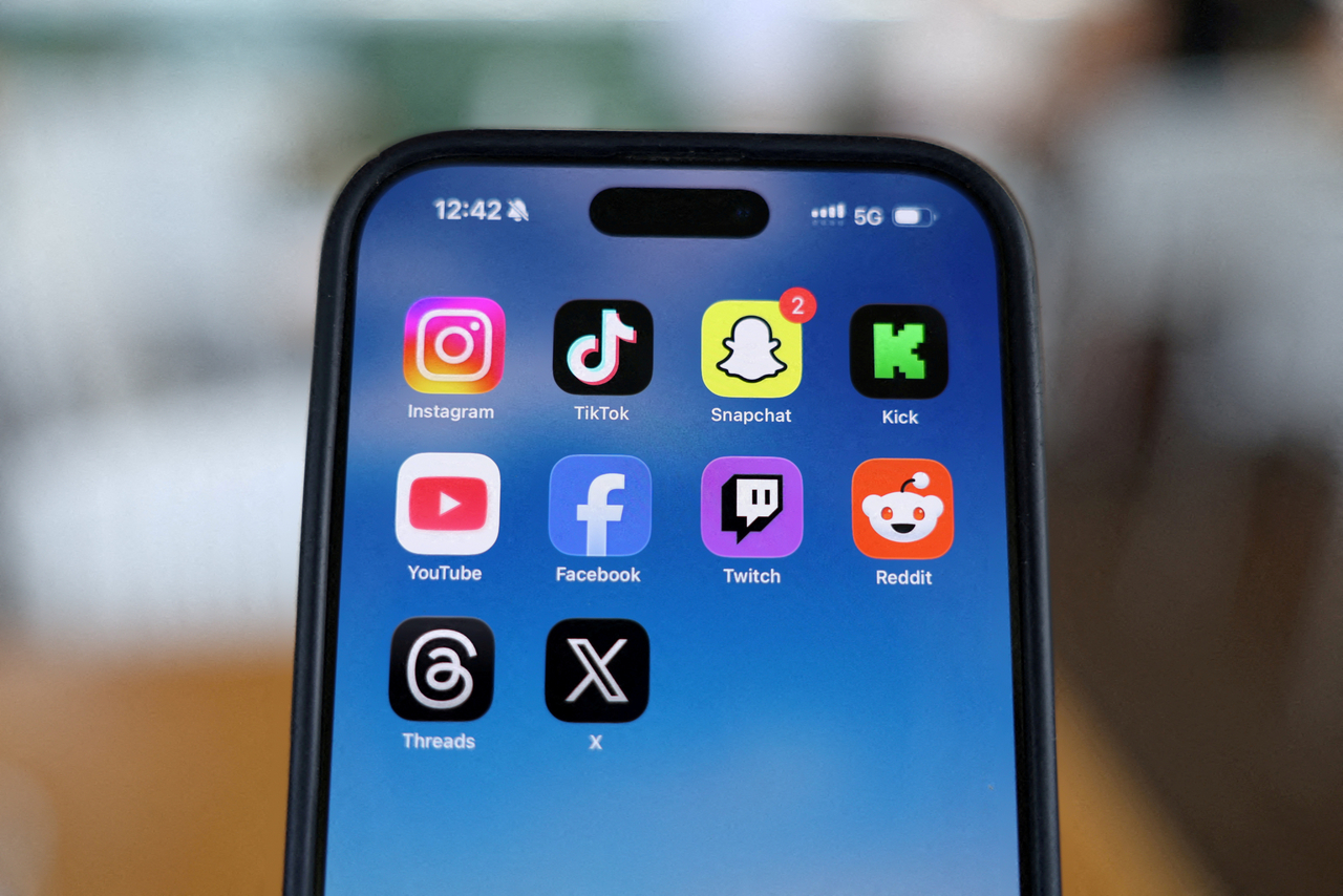 Instagram, TikTok, Snapchat, Kick, YouTube, Facebook, Twitch, Reddit, Threads and X applications are displayed on a mobile phone in this picture taken on Dec. 9.   Reuters-Yonhap