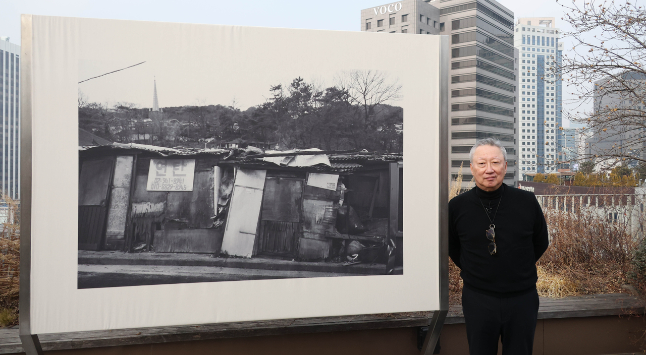 Park Yong-maan stands next to one of his photographs at Piknic in Seoul. (Park Yong-maan)