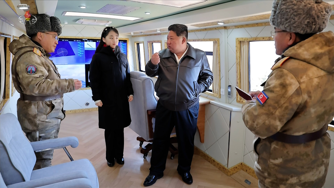 North Korean leader Kim Jong-un (center), accompanied by his daughter Ju-ae (second from left), oversees the test-fire of an upgraded large-caliber multiple rocket launcher system on Jan. 27, 2026, in footage aired by Korean Central Television on Wednesday. (Yonhap)