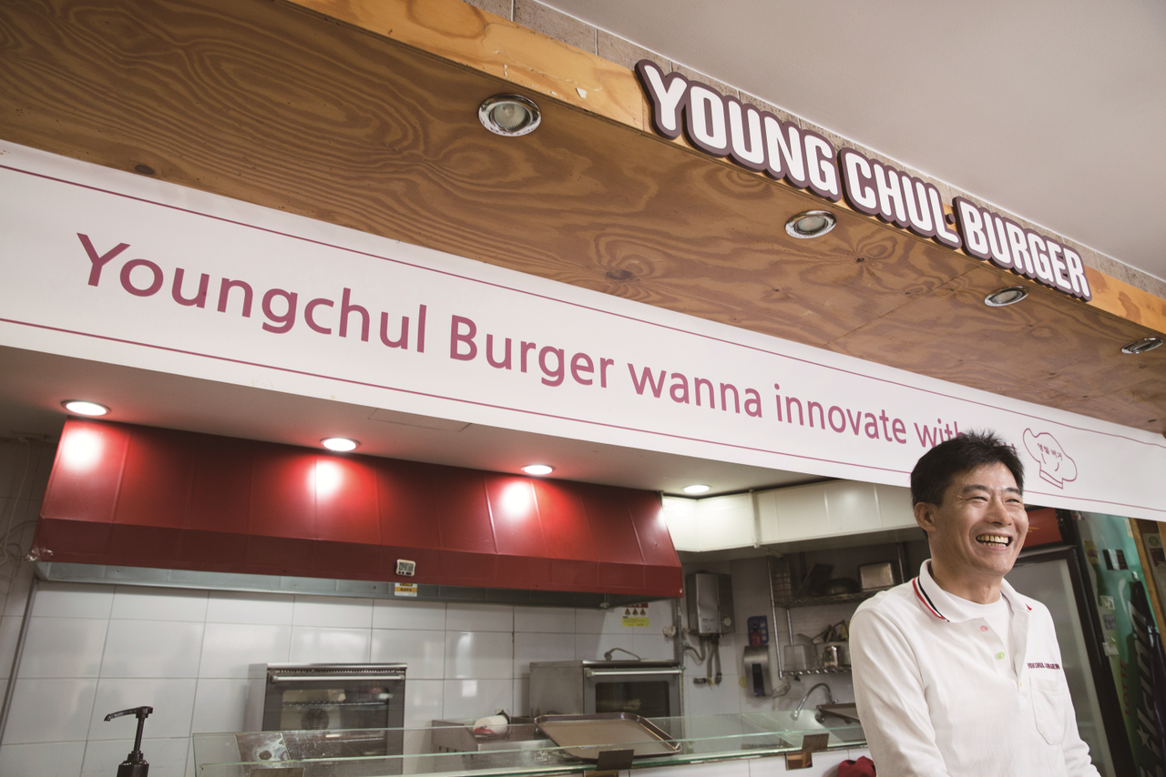 Lee Young-chul poses in front of Youngchul Burger near Korea University in this file photo released by Korea University Office of Development & External Affairs