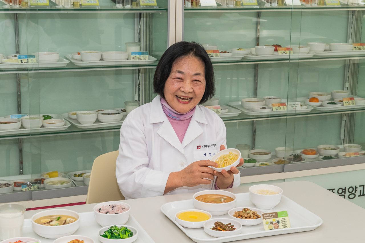 대구보건대 식품영양학과에 재학 중인 만학도 정점숙씨가 제49회 영양사 국가시험에 합격한 뒤 학과 실습실에서 기념촬영을 하고 있다.[대구보건대 제공]
