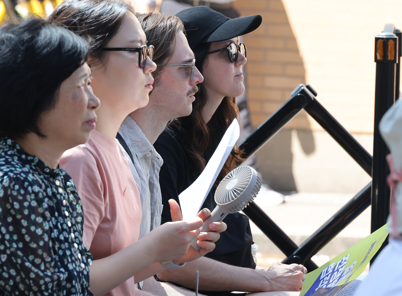 Foreign attendees listen to speakers near the Japanese Embassy in Seoul during a weekly rally calling for resolution of the Japanese military sexual slavery issue on Sept. 10, 2025. (Newsis)
