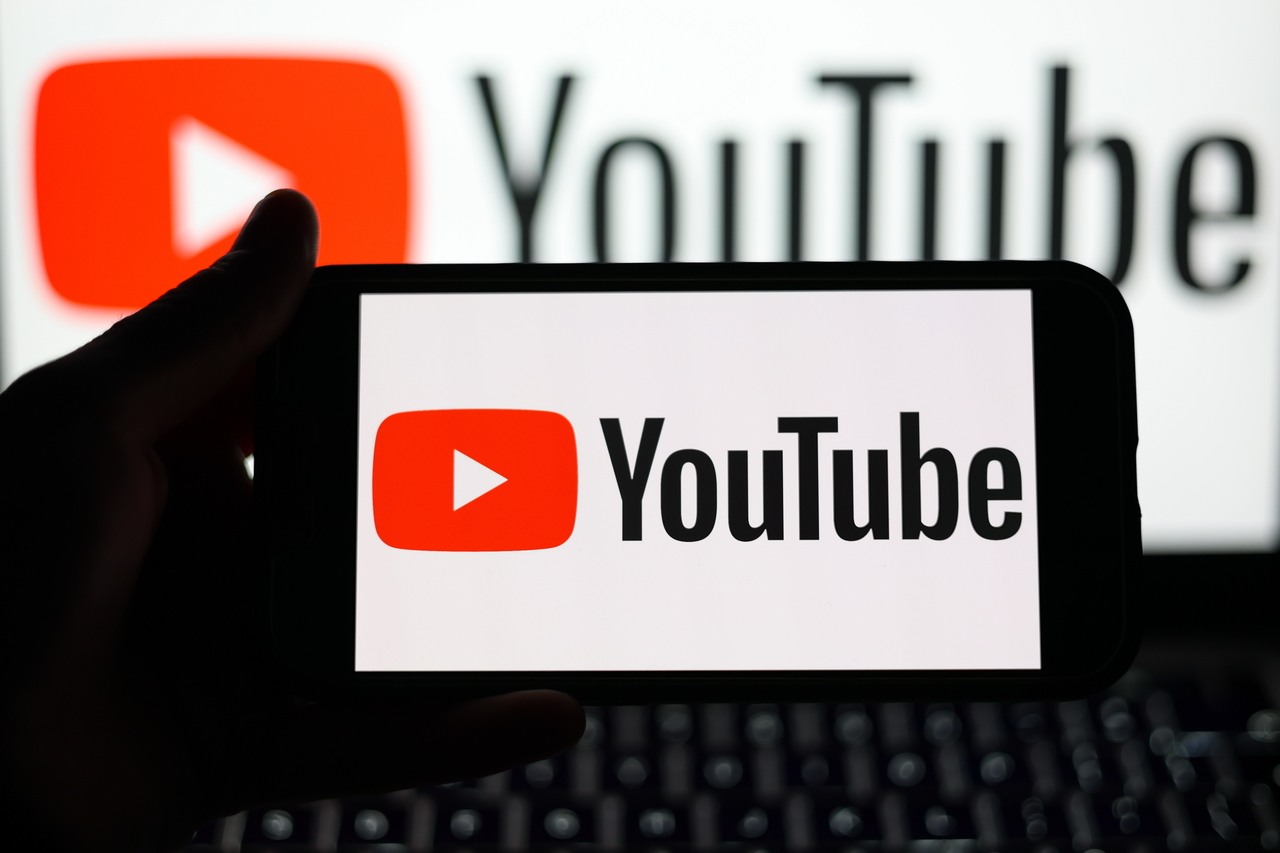 A Youtube logo displayed on a mobile phone and on a laptop screen (EPA-Yonhap)