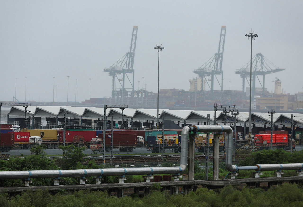 Trucks with shipping containers are parked at Jawaharlal Nehru Port, in Navi Mumbai, India, Aug. 27.   Reuters-Yonhap