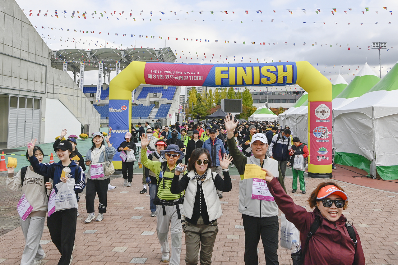 Participants of the Wonju Two Days Walk wave to the camera on Oct. 26, 2025. (Wonju)