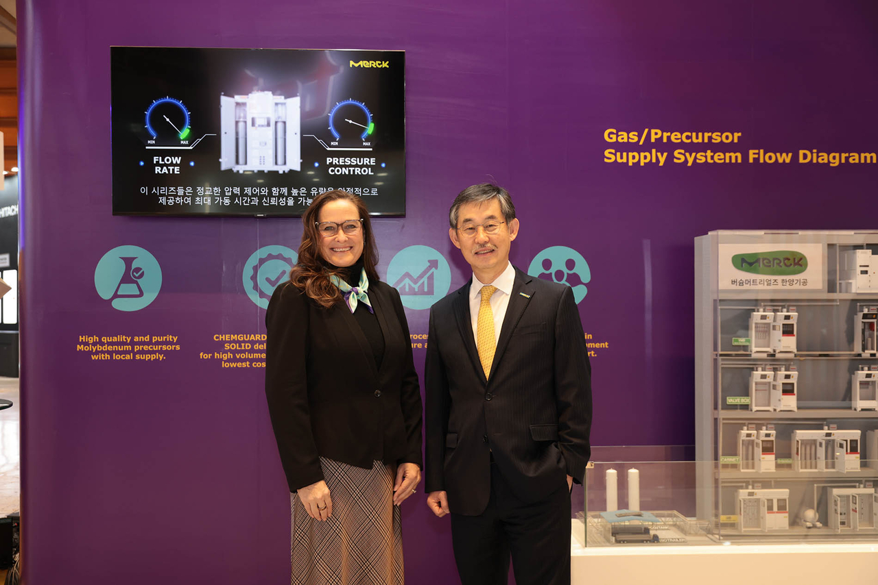 Katherine Dei Cas (left), executive vice president and global head of delivery systems and services and specialty gases at Merck Electronics KGaA, and Kim Woo-kyu, managing director at Merck Ltd. Korea, pose at Merck’s booth during Semicon Korea 2026 in Seoul on Wednesday. (Merck Korea)