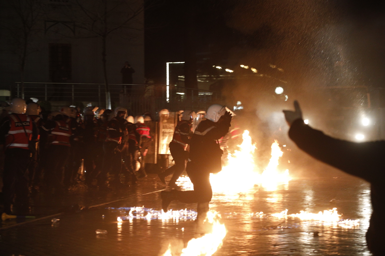 Police officers move away from a fire during an anti-government protest in Tirana, Albania, Tuesday. (EPA-Yonhap)