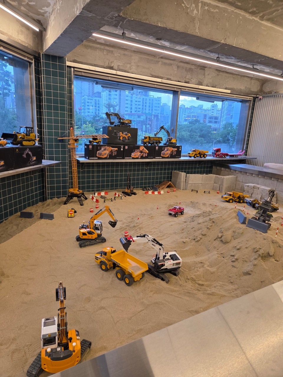 View of Diggerz RC cafe, where visitors can operate remote-controlled construction vehicles inside a miniature worksite (Instagram)