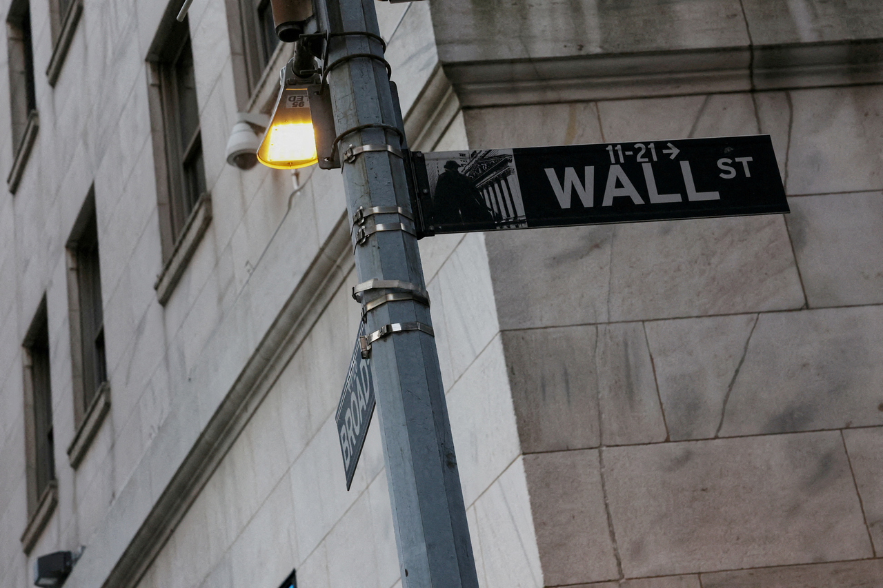 The Wall Street sign hangs outside the New York Stock Exchange building on Tuesday following Monday?s broad sell off in New York City, U.S., March 11, 2025.  (Reuters-Yonhap)