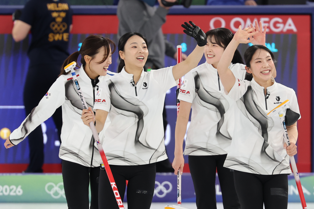 Members of the South Korean women's curling team celebrate their win over Sweden in a round-robin match in the women's curling tournament at the Winter Olympics at Cortina Curling Olympic Stadium in Cortina d'Ampezzo, Italy, on Wednesday. From left: Gim Eun-ji, Kim Min-ji, Seol Ye-eun and Kim Su-ji. (Yonhap)