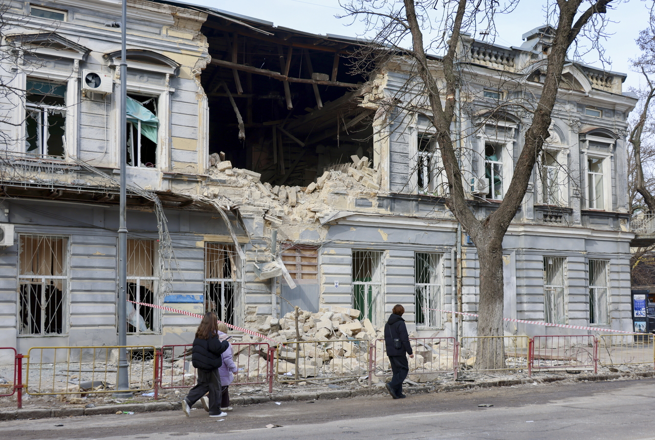 People walk past the site of a Russian drone strike in Odesa, Ukraine, Saturday. (EPA-Yonhap)
