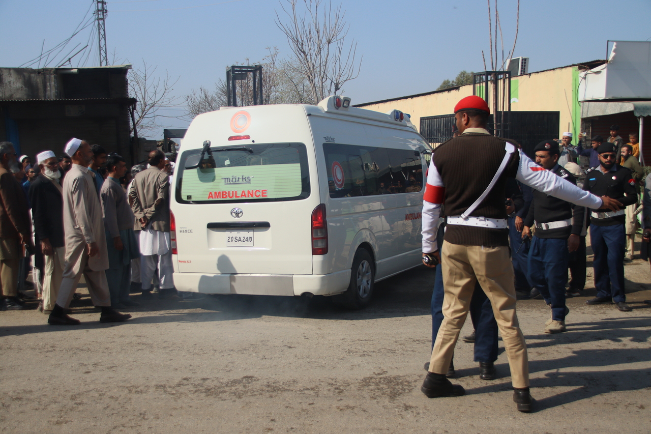 An ambulance carrying the body of a dead person is seen after a suicide bomb attack in Mansehra, Pakistan, Sunday. (EPA-Yonhap)