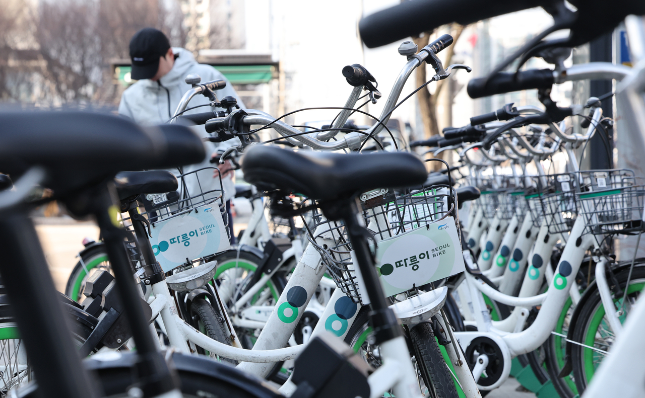 A pedestrian uses one of Seoul’s public bicycles, "Ddareungi." (Yonhap)