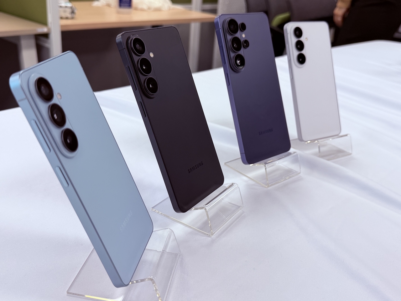 The Galaxy S26 series is on display at Samsung's Seoul media briefing Thursday, showing (from left) the S26+ in Sky Blue, S26+ in Black, the S26 Ultra in Cobalt Violet and the S26 in White. (Moon Joon-hyun/The Korea Herald)