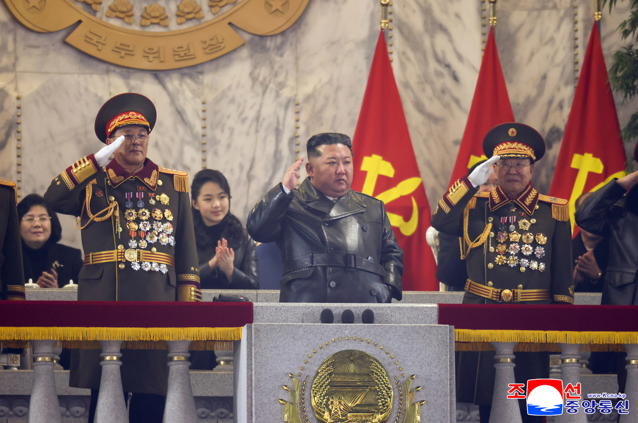 Kim Jong-un (center) salutes alongside senior military officials during a military parade commemorating the 9th Congress of the North Korea's Workers’ Party, held on Wednesday at Kim Il Sung Square in Pyongyang, according to footage released by the Korean Central News Agency. (KCNA via Yonhap)