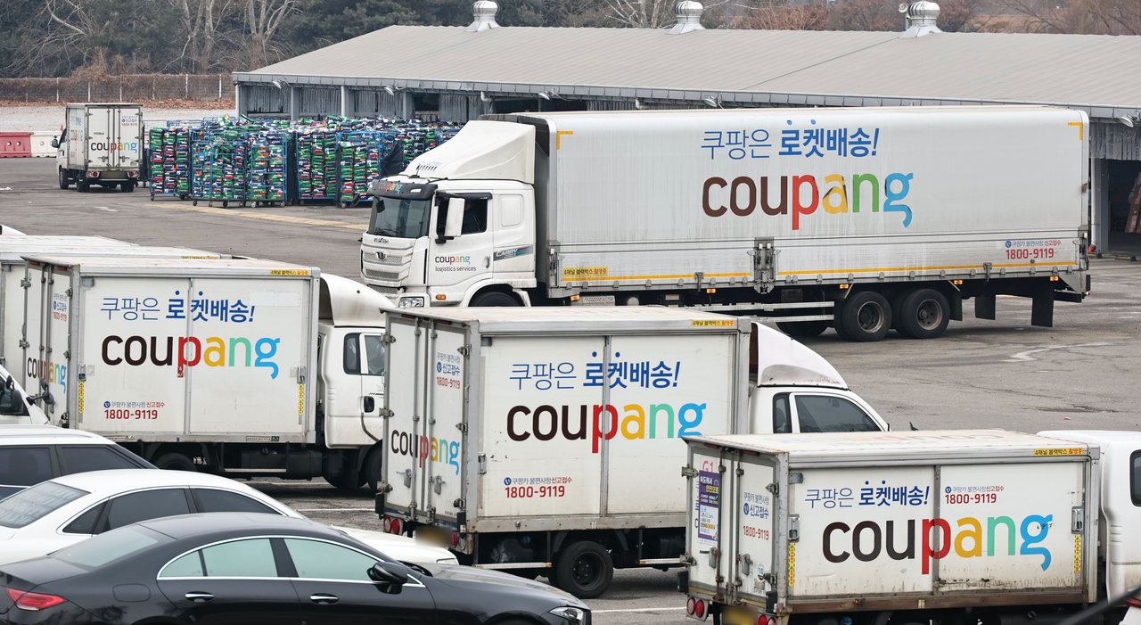 Delivery trucks are parked at a Coupang logistics center in Seoul. (Yonhap)