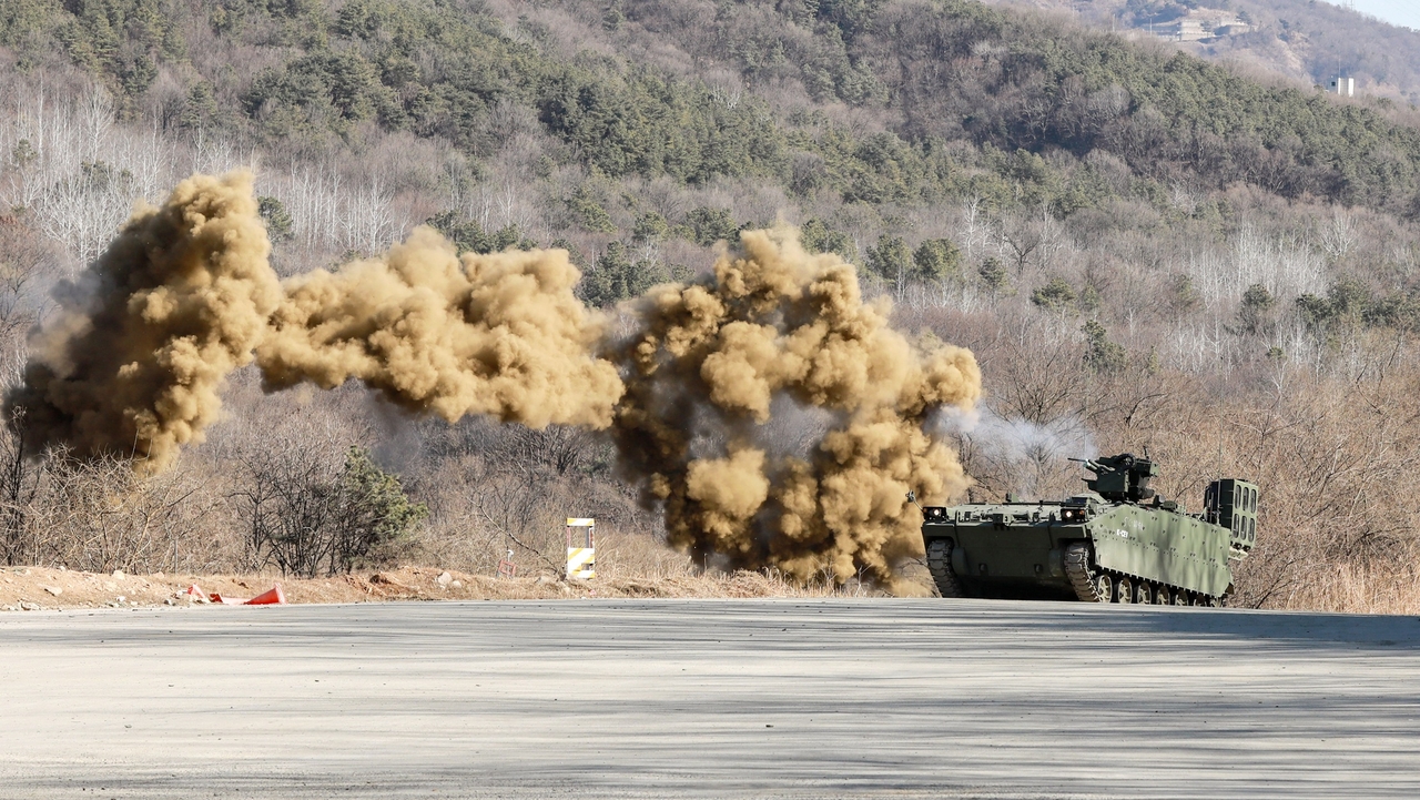 A Korean Combat Engineer Vehicle fires its weapons after deploying smoke grenades during a drill Thursday in Yangpyeong, Gyeonggi Province. (Army)