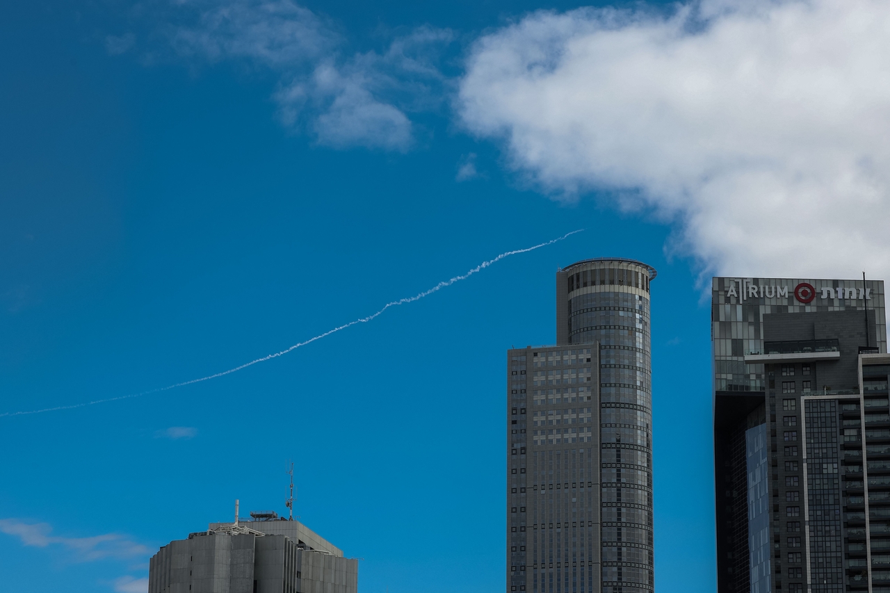 Rocket trail from Israel's Iron Dome missile defence system is seen over  in Tel Aviv on Saturday.   AFP-Yonhap