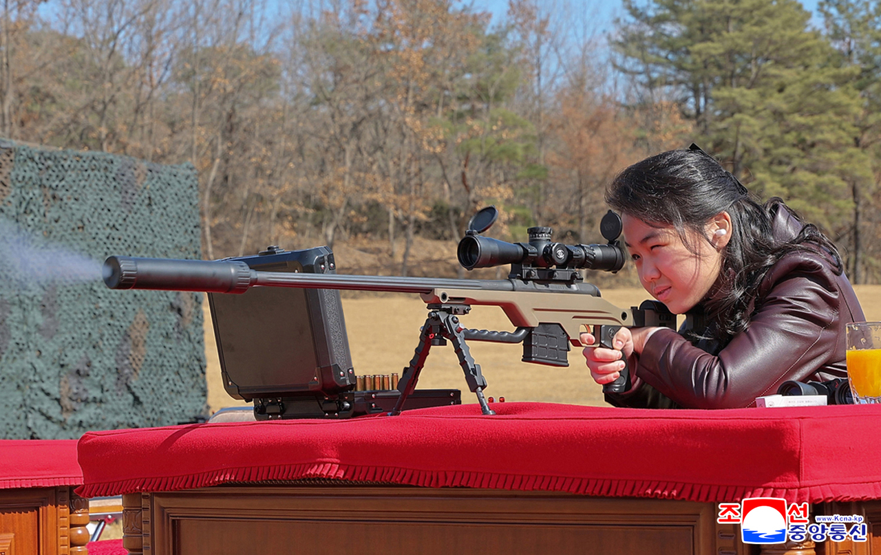 North Korean leader Kim Jong-un's daughter Ju-ae takes aim at a target with a sniper rifle at a firing range on Friday in this photo carried by the North's official Korean Central News Agency the following day. (Yonhap)