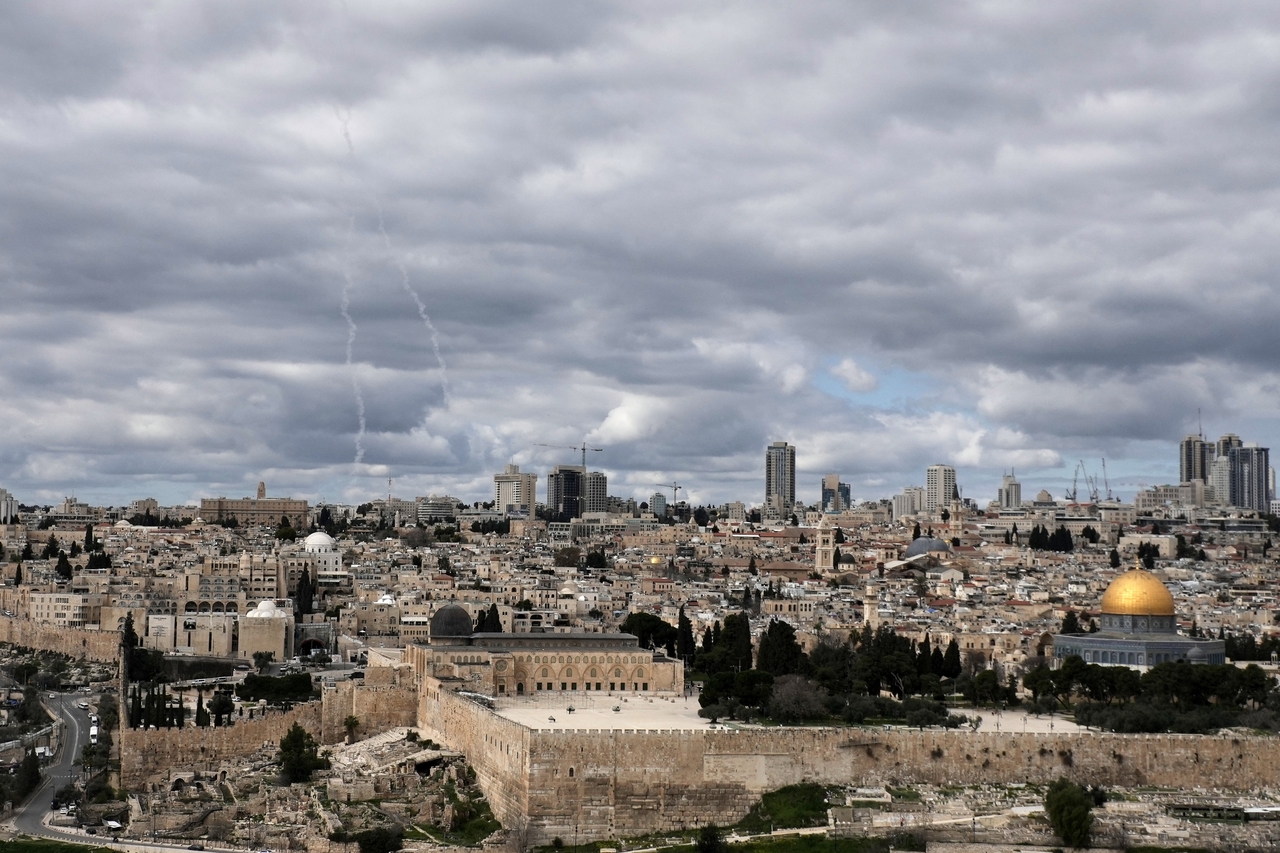 Traces of an air defense missile interception are seen, left, over Jerusalem's Old City, Saturday. (AP Photo/Mahmoud Illean)