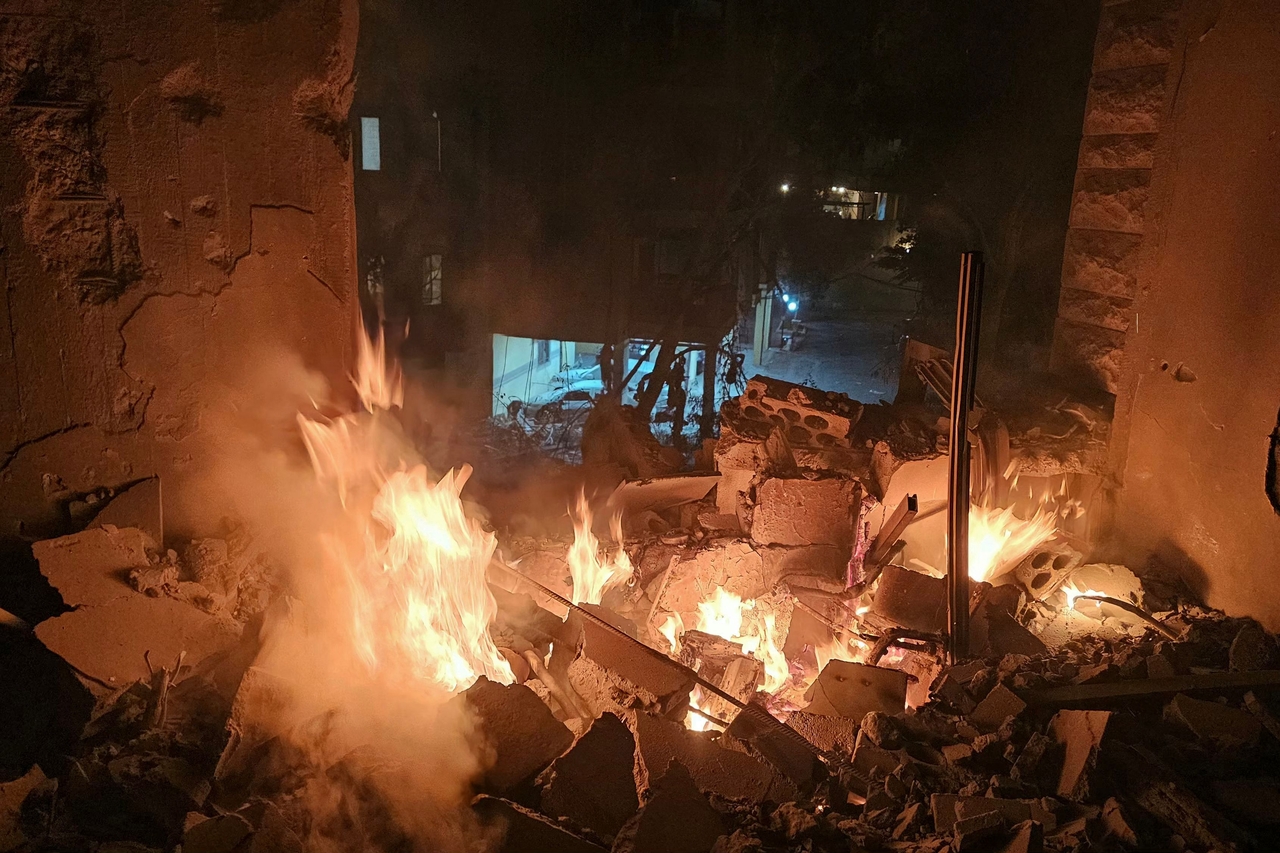Fire erupts in a building damaged in an Israeli air strike in the southern Beirut suburb of Haret Hreik on Monday. (AFP-Yonhap)